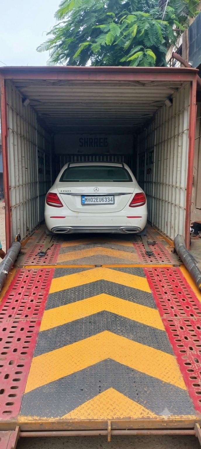 Sedan loaded and secured inside a carrier truck